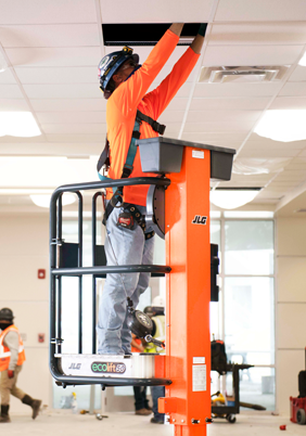 Operator works on speaker from JLG® EcoLift platform