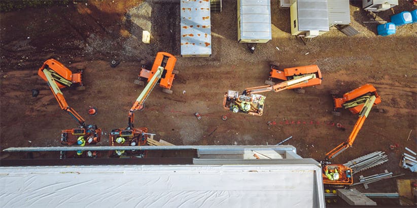 Aerial shot of four JLG boom lifts