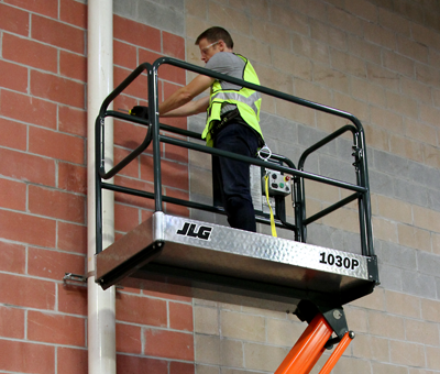 Operator hangs office décor with JLG® 830P