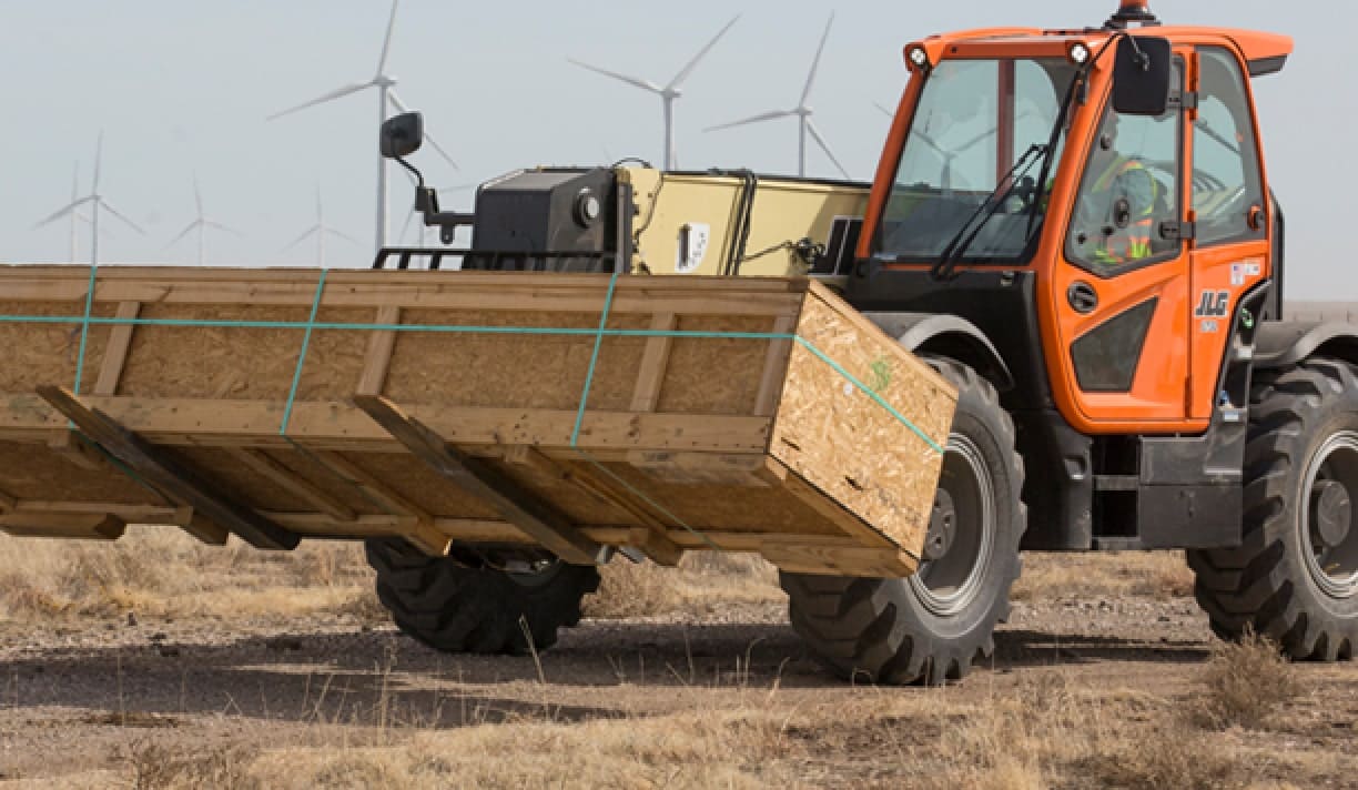 Telehandler moving large load using fork attachment