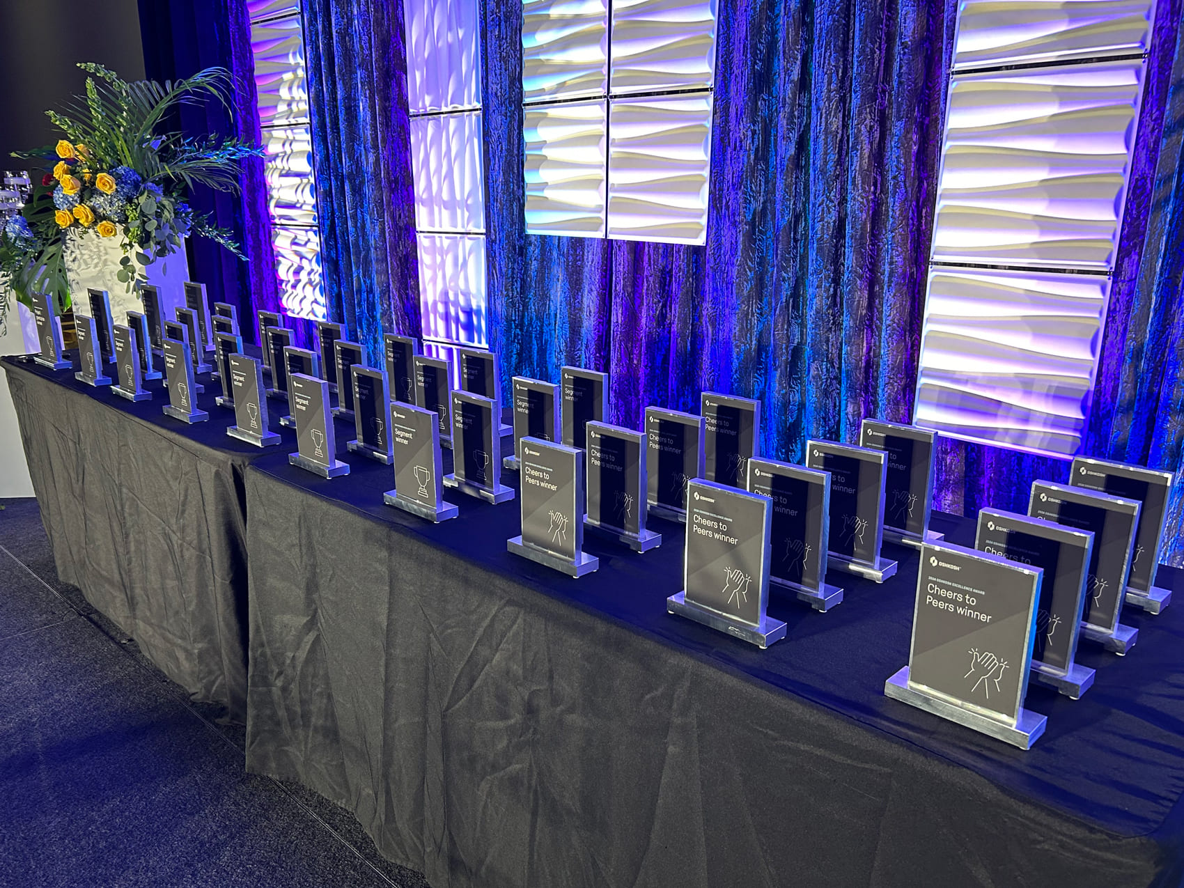Oshkosh Excellence Awards trophies on a table 