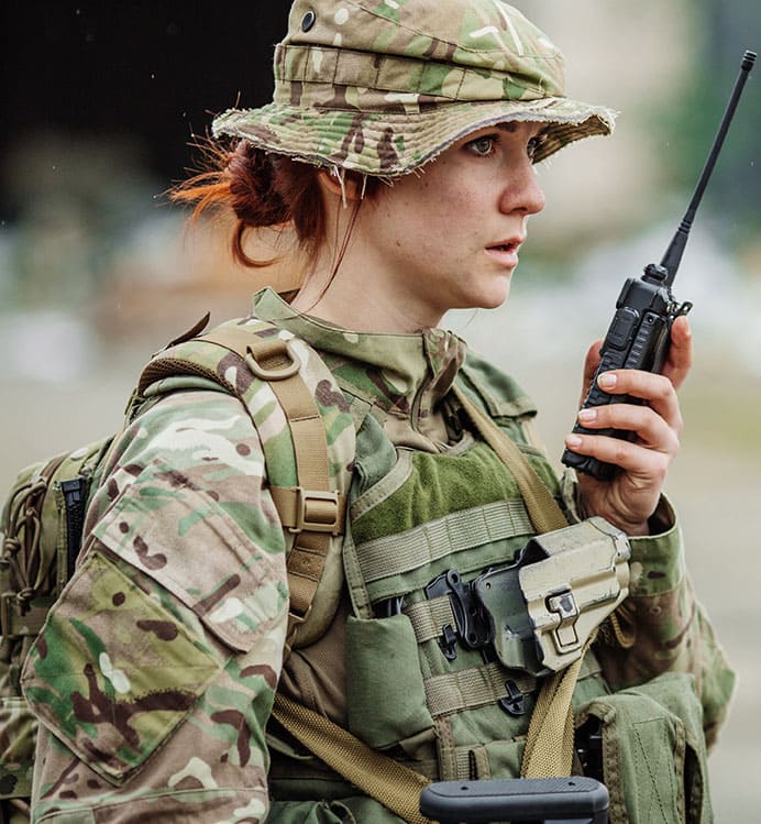 Female soldier talking on a two-way radio