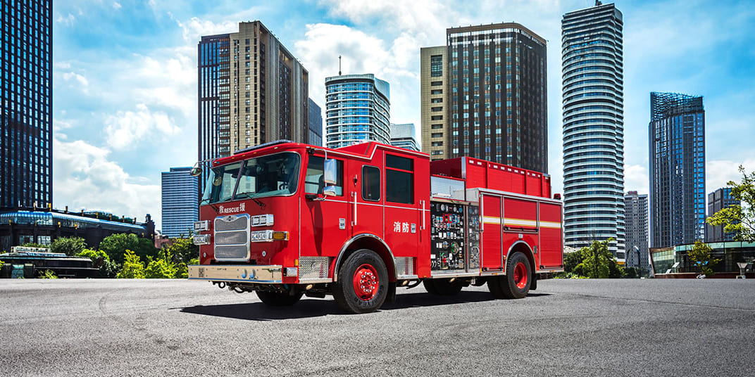 Red Pierce Ultra highrise pumper parked outside a city