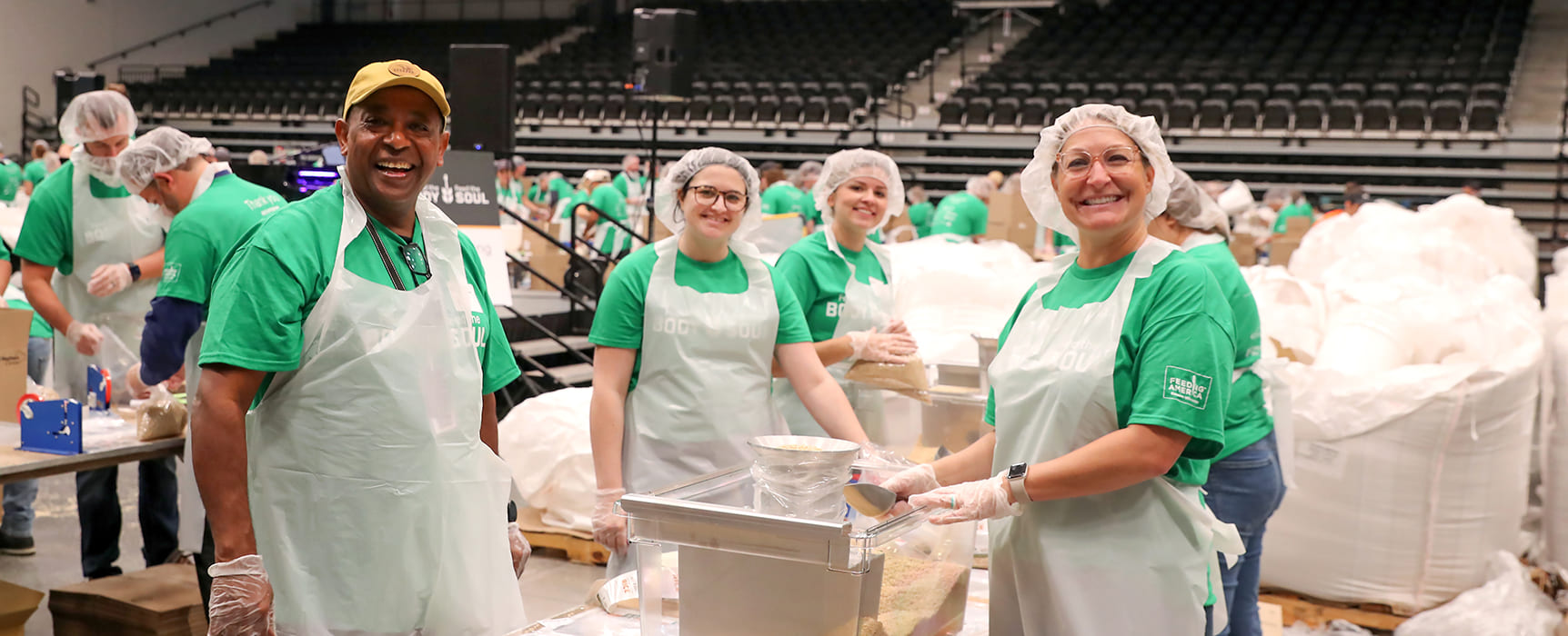 Community members volunteering at Oshkosh Corporations Feed the Body, Feed the Soul event